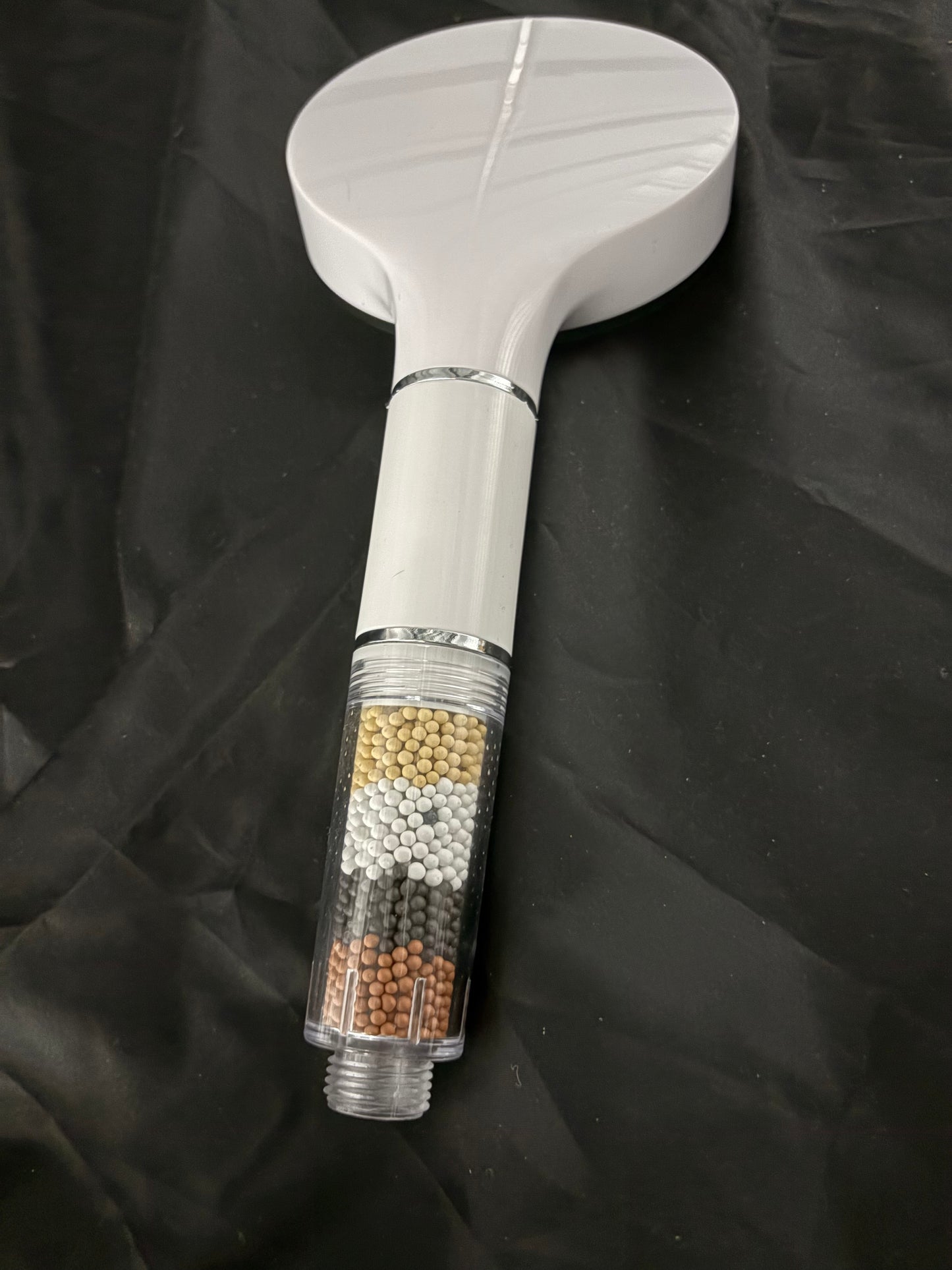Shower head with water purifying beads