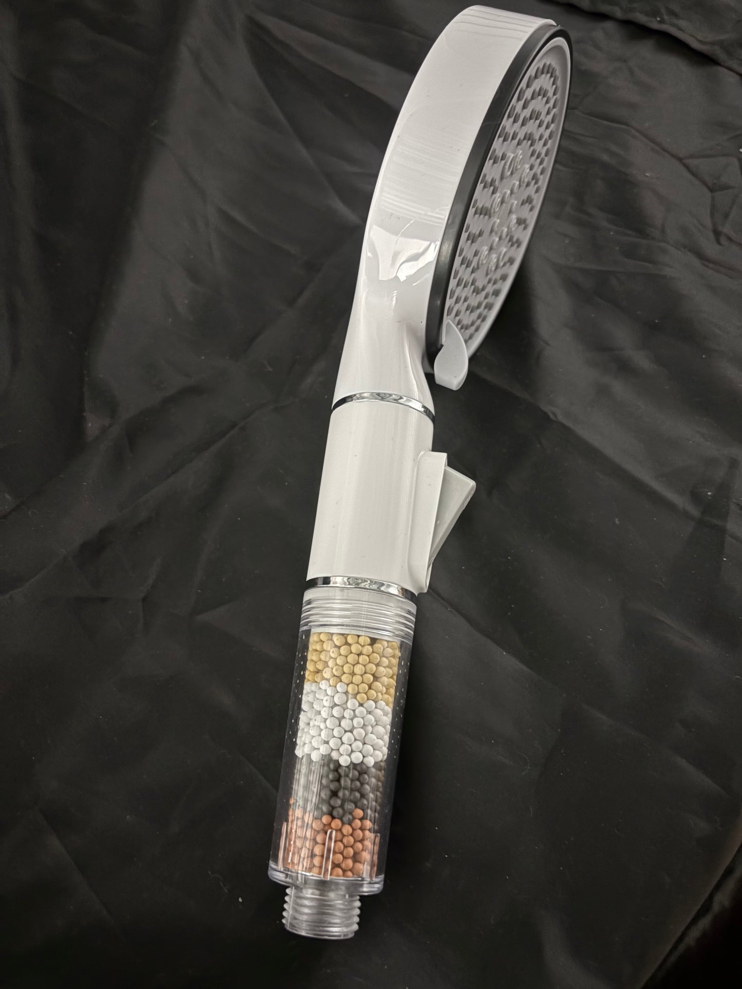 Shower head with water purifying beads