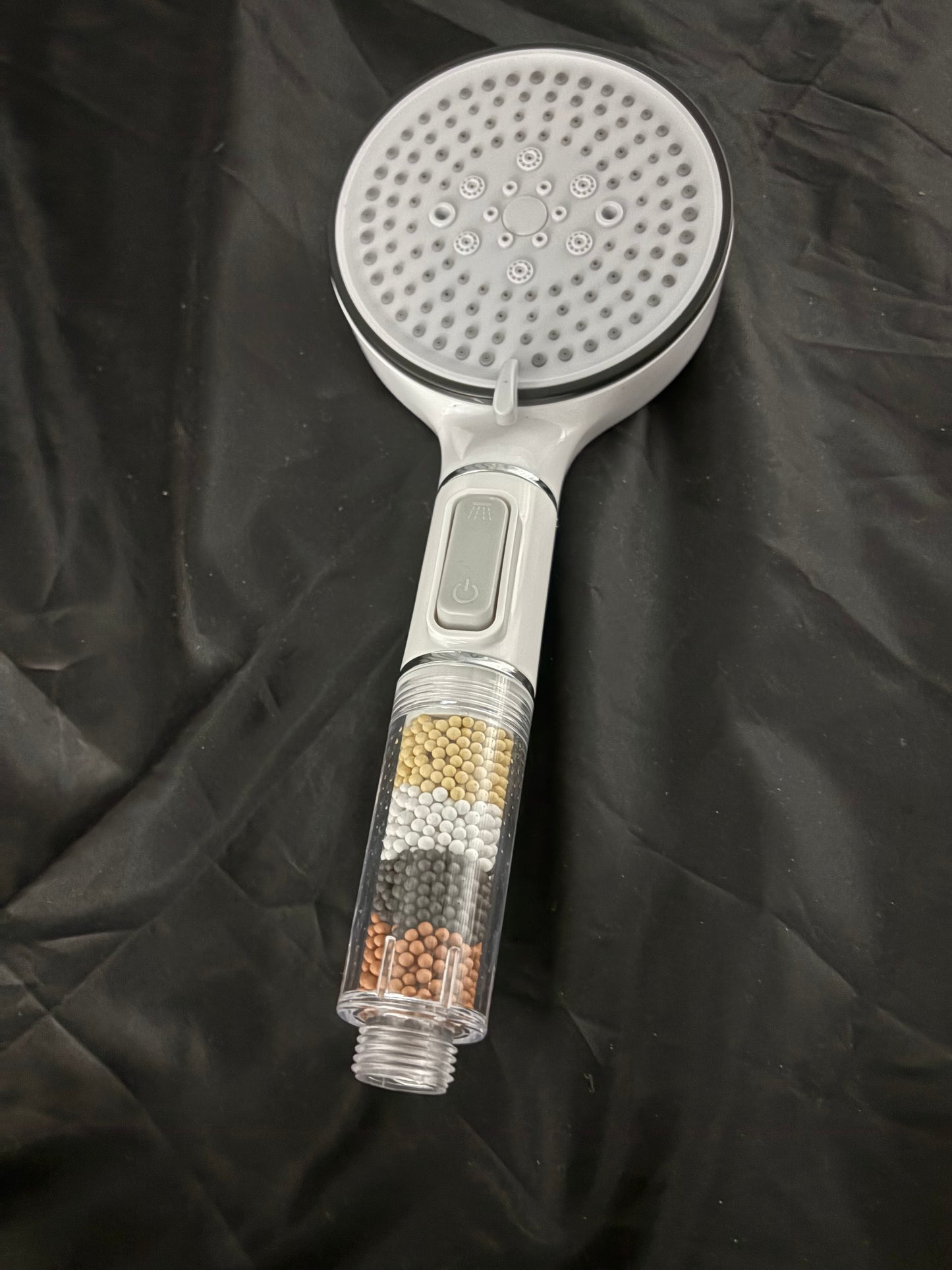 Shower head with water purifying beads
