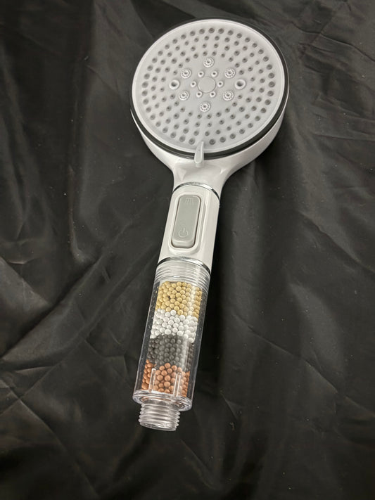Shower head with water purifying beads